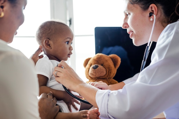 Caring Pediatrician Examines Young Patient